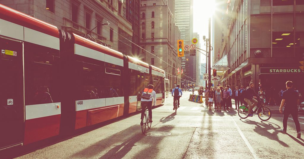 cyclist riding alongside Toronto streetcar