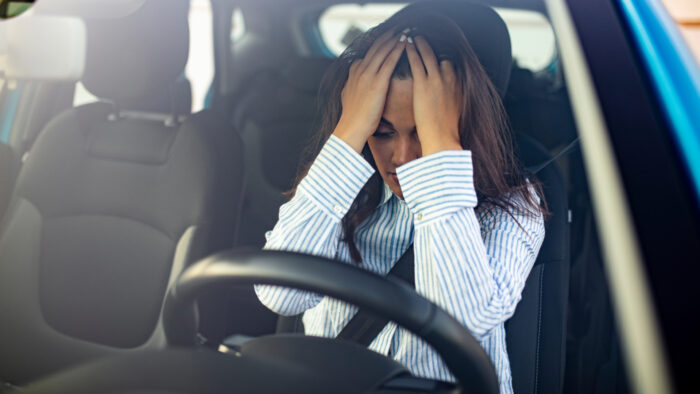 a woman being depressed in her car