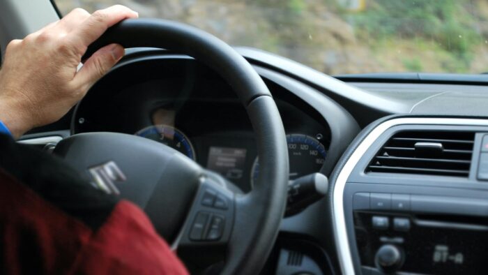 Hand on steering wheel